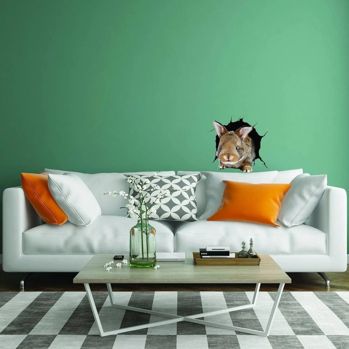 3D wall sticker of a whimsical rabbit on a green wall above a modern white sofa with orange cushions.