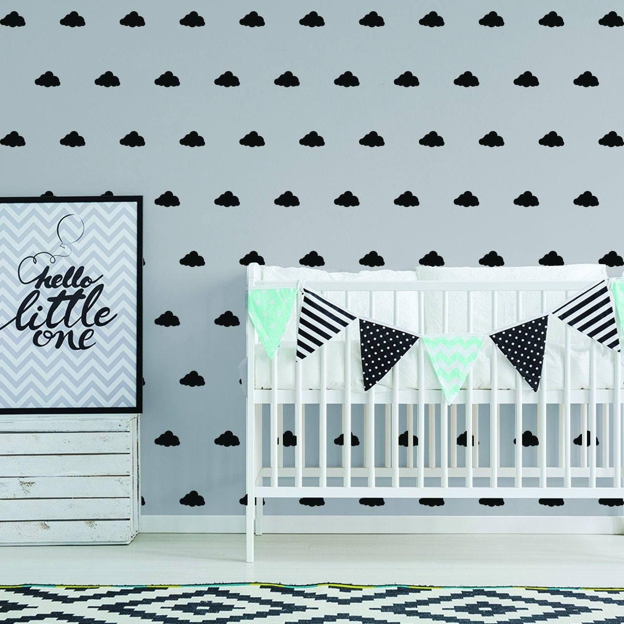 Charming nursery with WhimsiCloud children's wall stickers, featuring black cloud decals and a cozy crib.