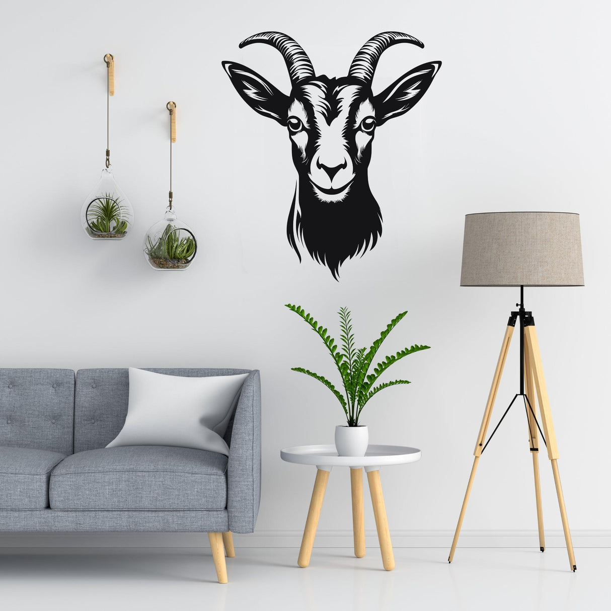 Vinyl goat wall sticker decal in light black, enhancing rustic decor beside a modern sofa and plant.
