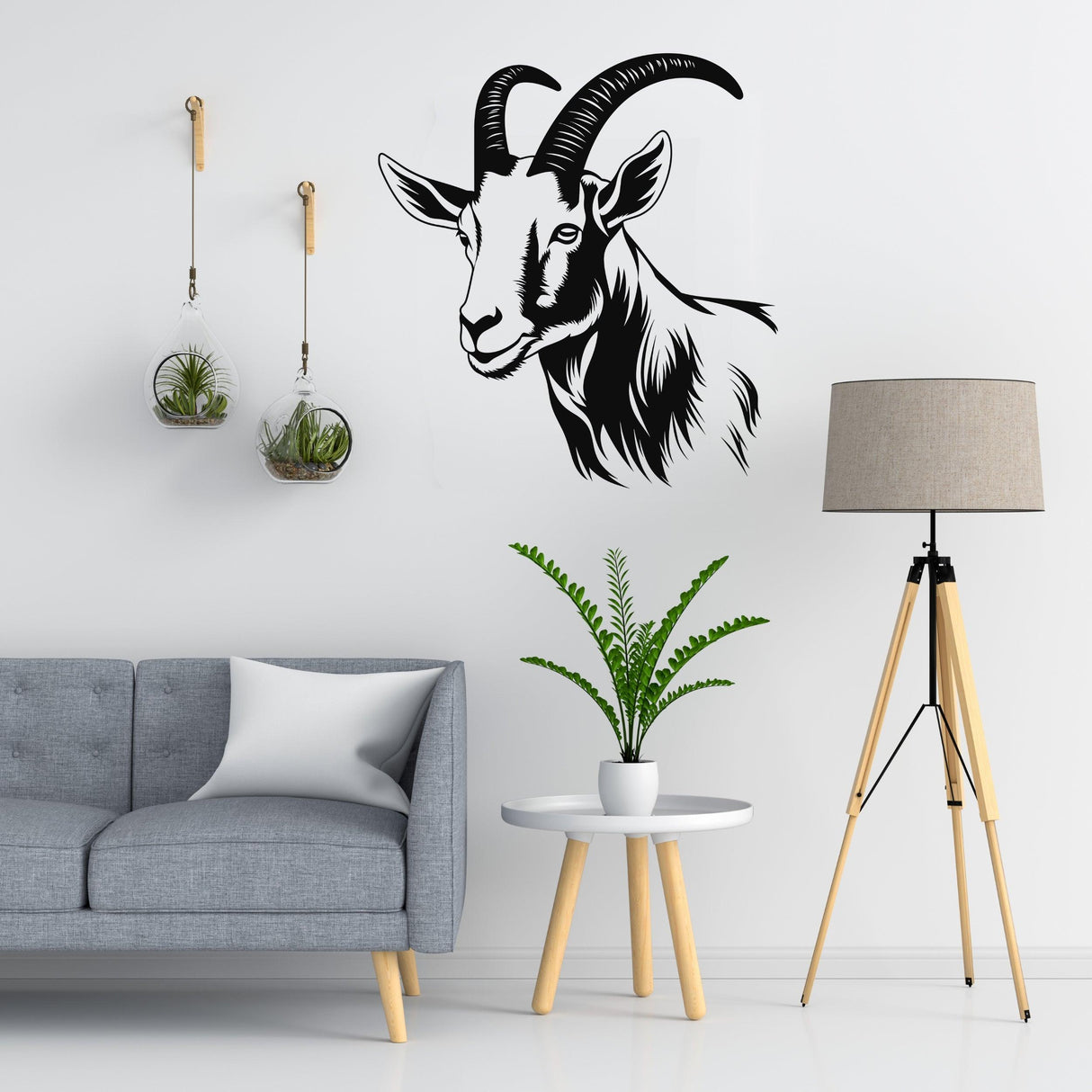 Graceful goat wall decal on white wall above minimalist living room decor with plants and lamp.