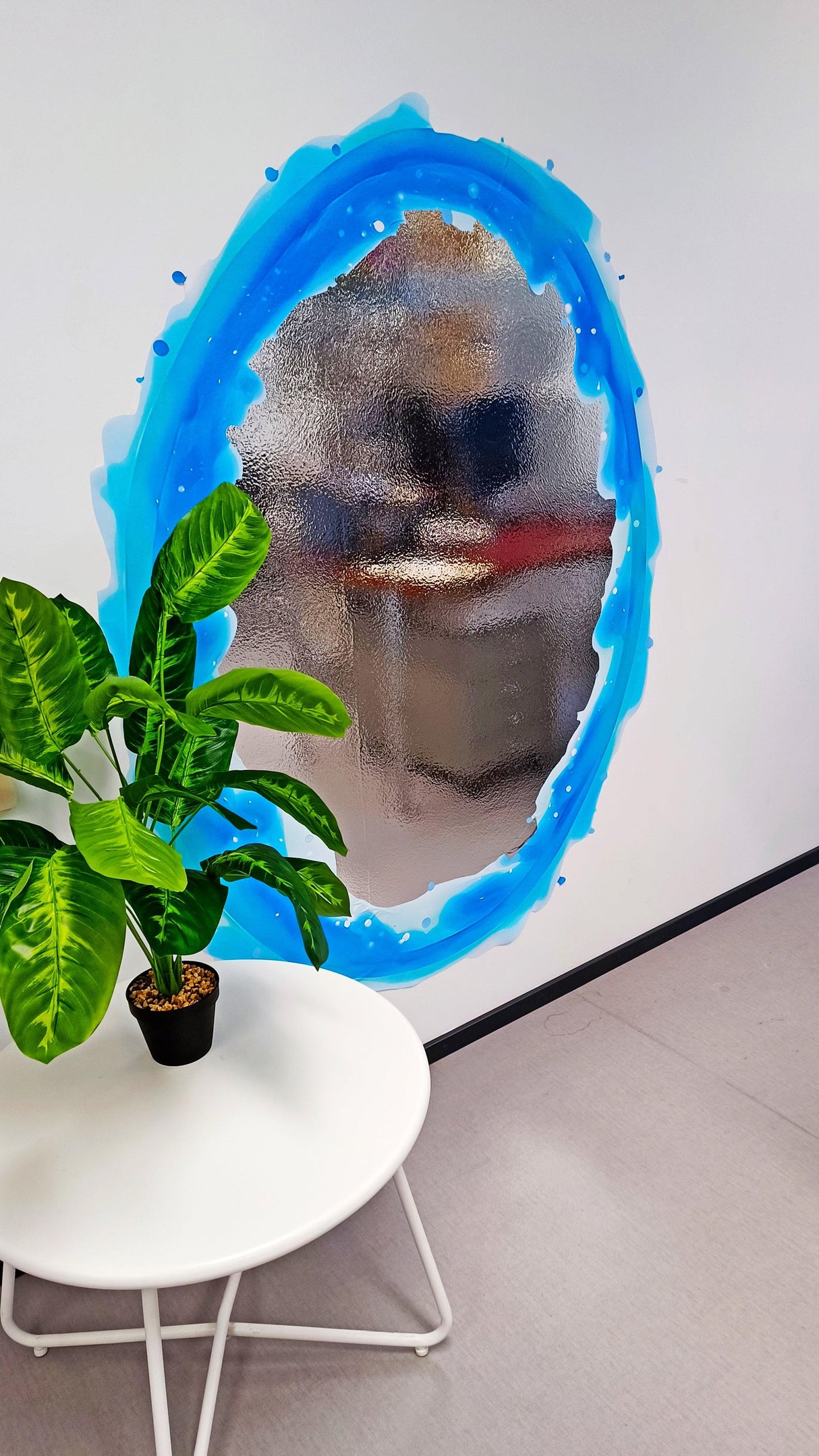 Custom blue and orange portal wall sticker with vibrant design, featuring a plant and a table in the decor.