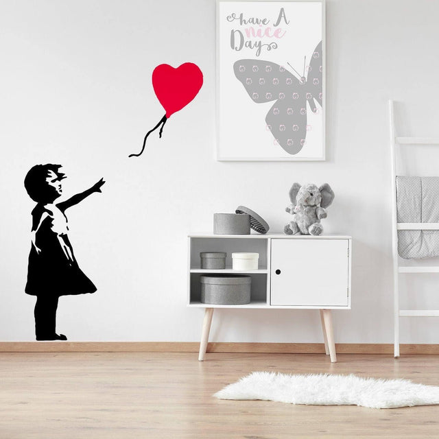 Vinyl wall decal of girl with heart balloon in modern room, adding whimsy and hope to decor.