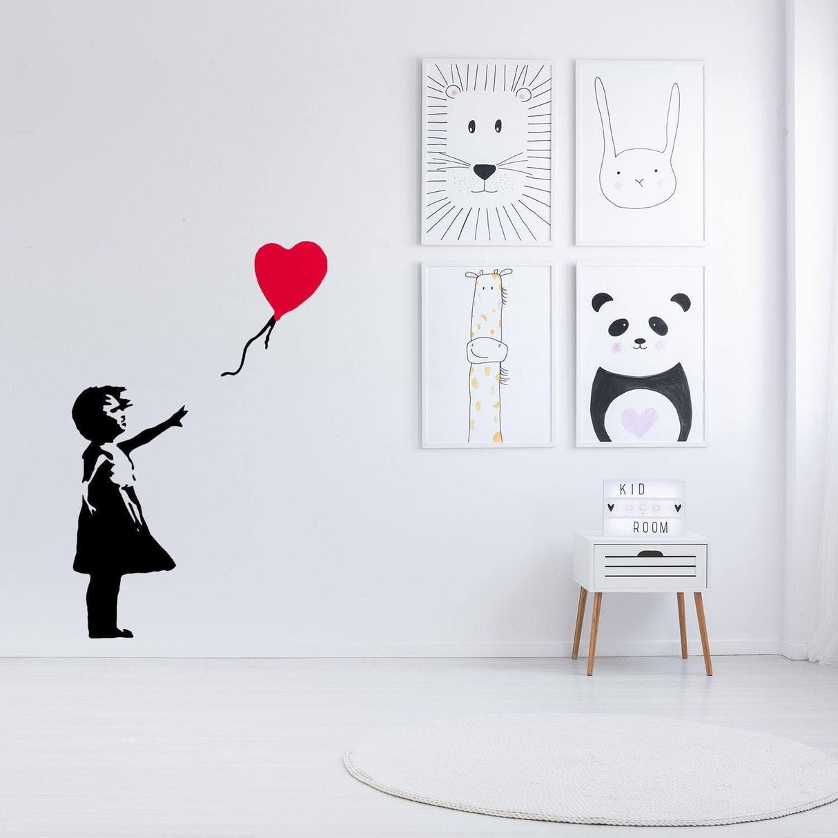 Banksy-style vinyl wall decal of girl with heart balloon in a modern kid's room decor.