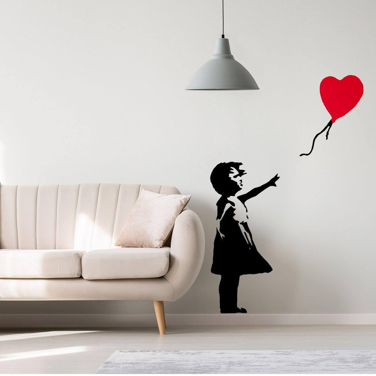 Vinyl wall decal of a girl reaching for a red heart balloon, adding whimsy and hope to a stylish living space.