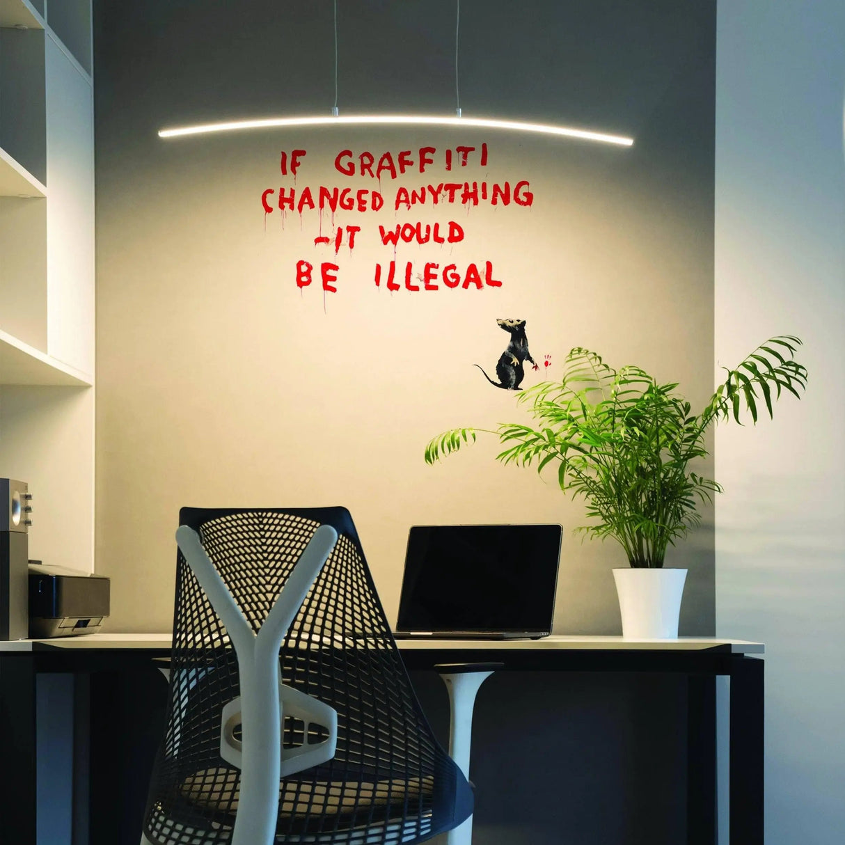 Artistic urban wall decal featuring a graffiti rat and text in a modern office setting.
