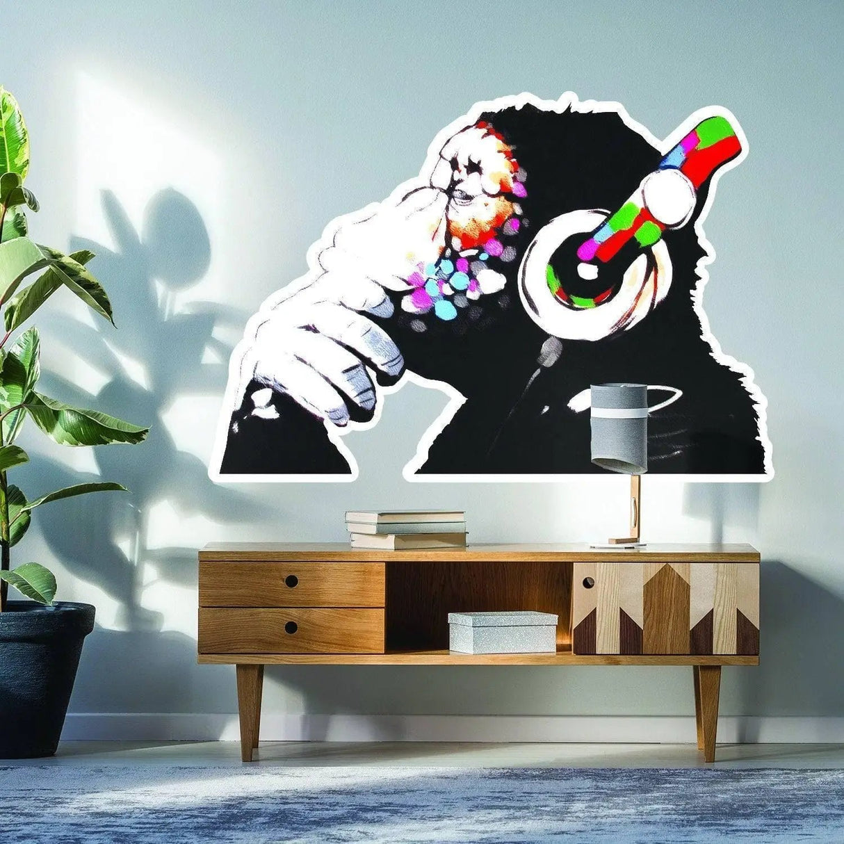 Contemplative monkey wall sticker in a modern living room setting, adding vibrant decor.