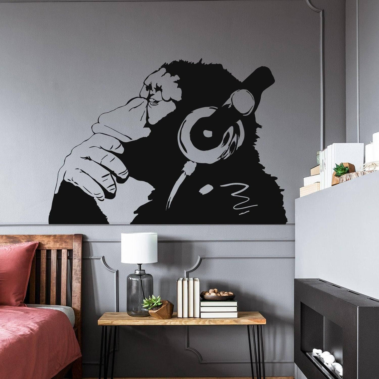 Contemplative primate wall art sticker featuring a monkey with headphones in a stylish room setting.