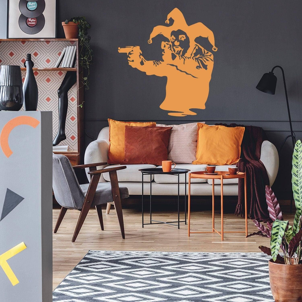 Banksy-inspired Joker clown wall decal with gun in modern living room decor.