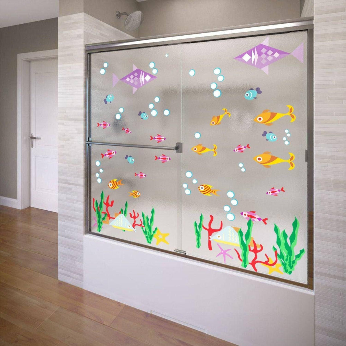 Colorful fish and coral vinyl decals decorating a shower door, creating a whimsical underwater theme.