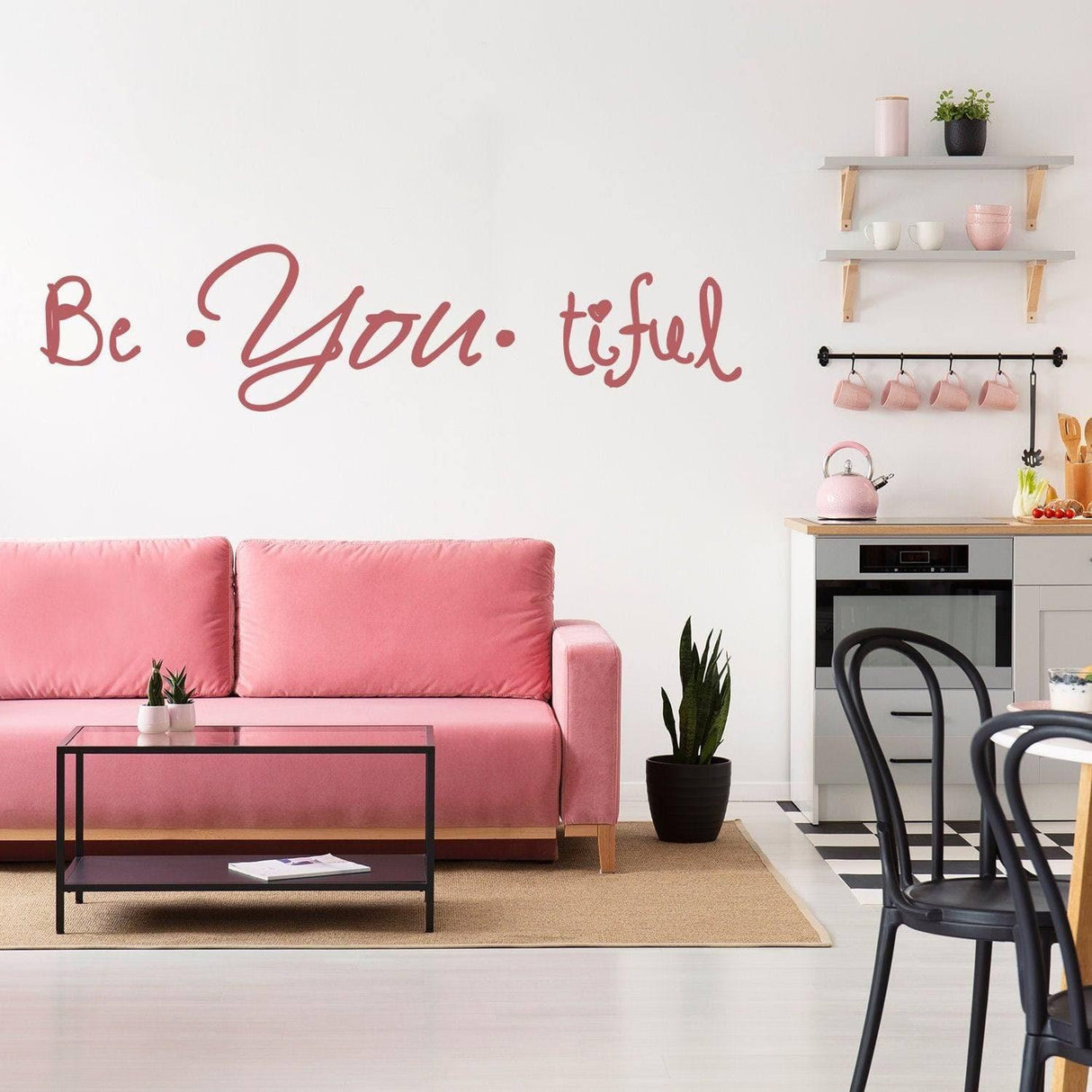 Inspire Beauty wall decal 'Be You tiful' above a pink sofa in a modern living room setting.