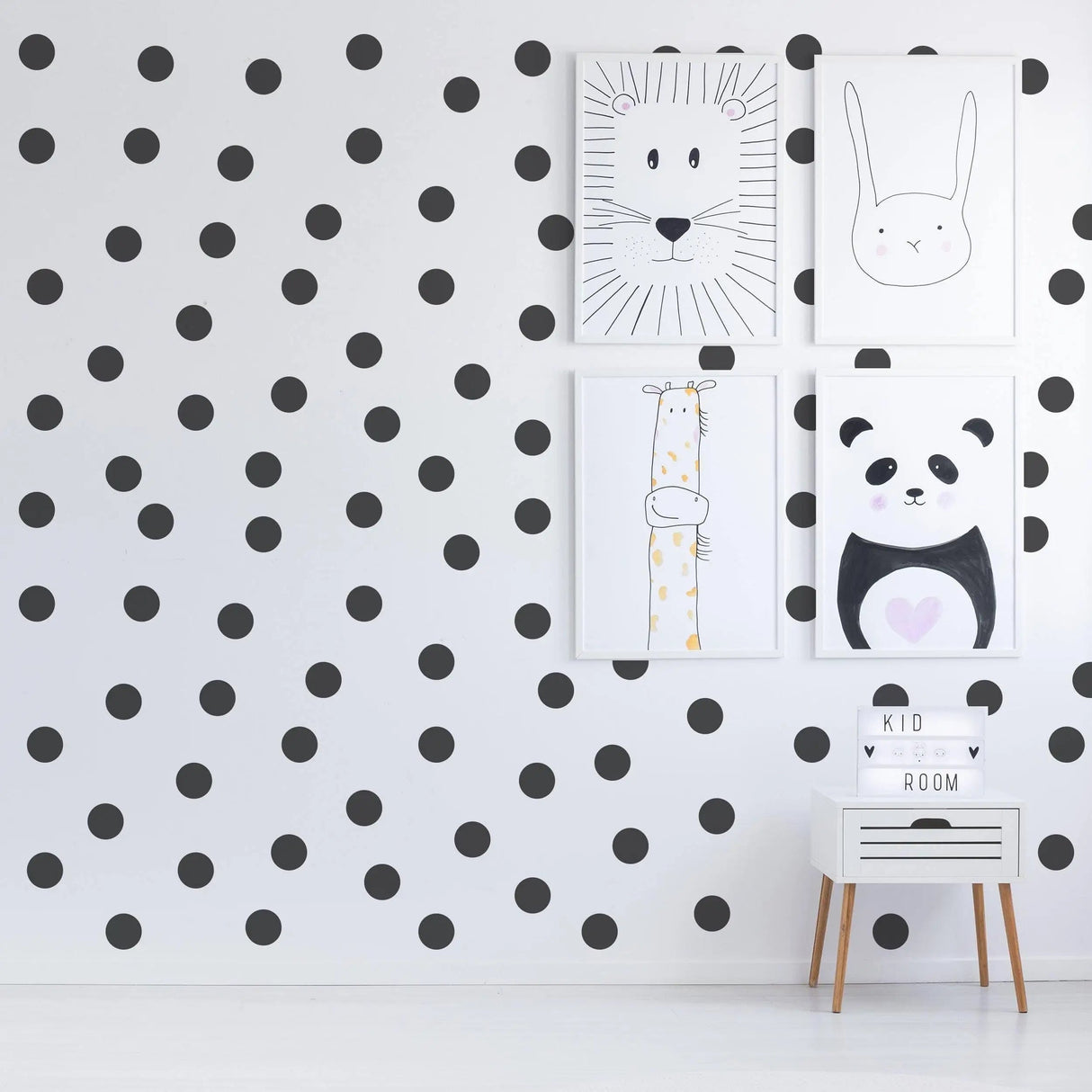 Stylish interior featuring black circle wall stickers and cute animal art prints in a kid's room.