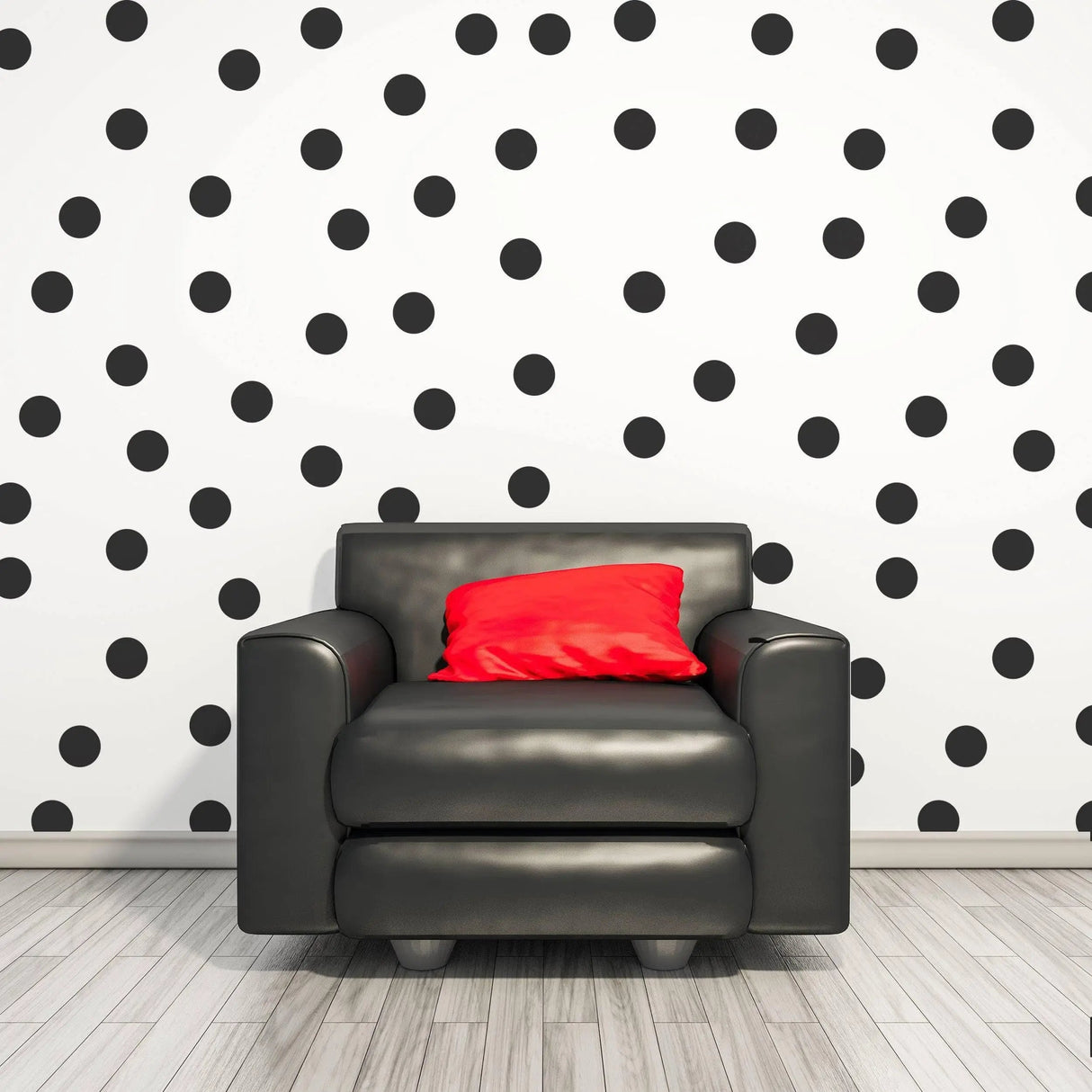 Living room featuring black circle wall stickers on white wall and a black armchair with a red pillow.