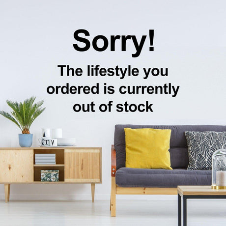 Creative vinyl wall decal with 'Sorry! The lifestyle you ordered is currently out of stock' quote in stylish living room decor.