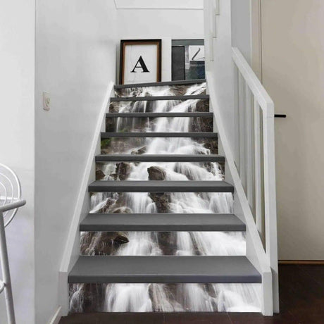 Staircase decorated with waterfall vinyl sticker decals enhancing home decor with artistic design.