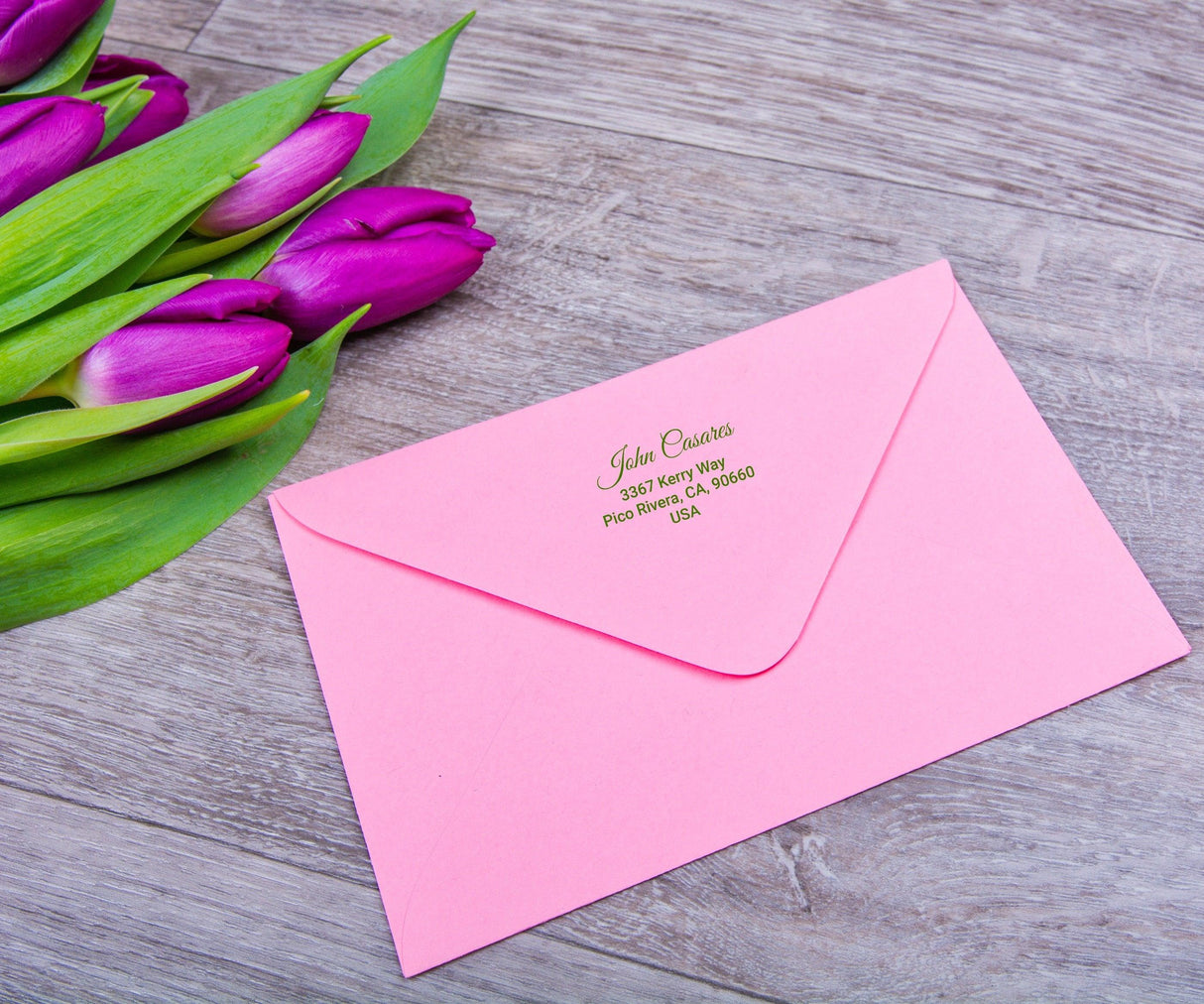 Custom clear mailing label on a pink envelope with tulips, showcasing personalized address printing.