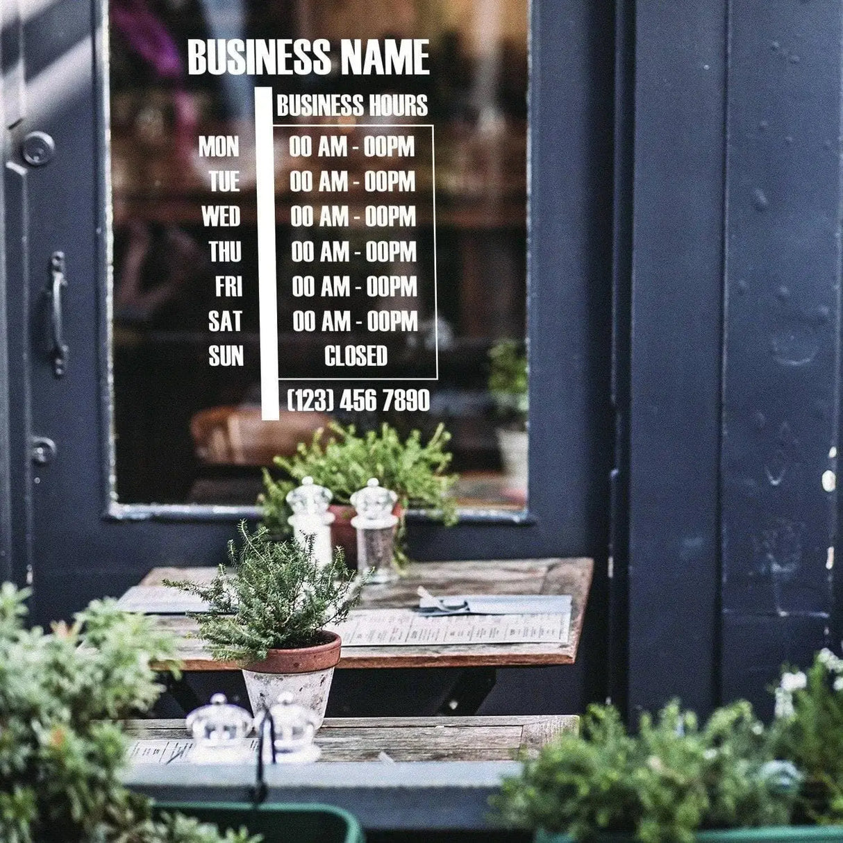 Personalized vinyl business hours decal displayed on a storefront window with clear schedule and contact number.