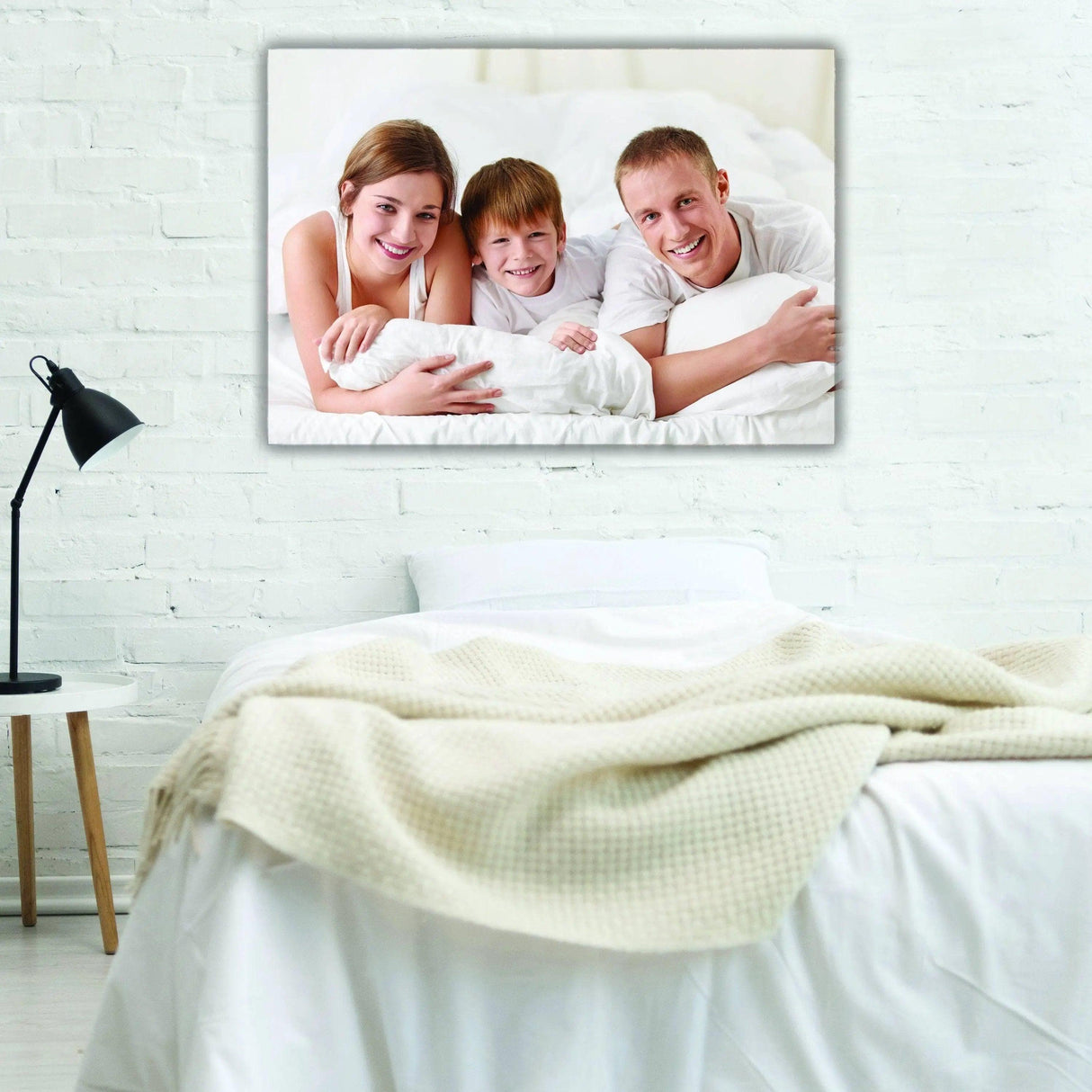 Family enjoying moments together on a cozy bed, showcased in a personalized canvas wall art.