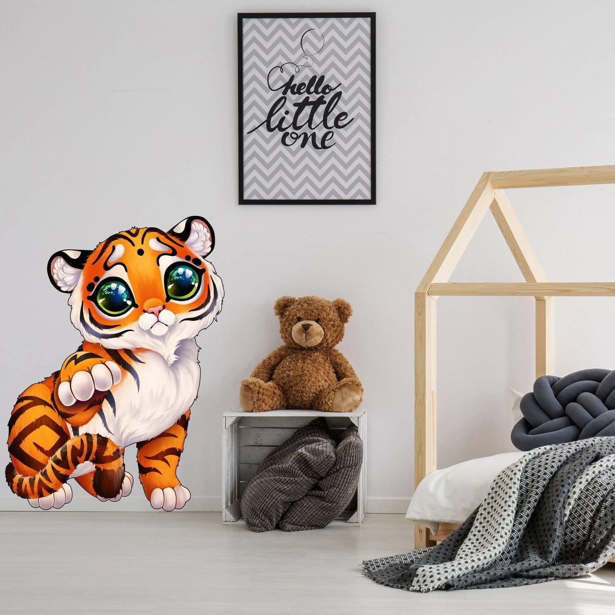 Cute whimsical tiger wall decal in a cozy nursery with teddy bear and modern decor.