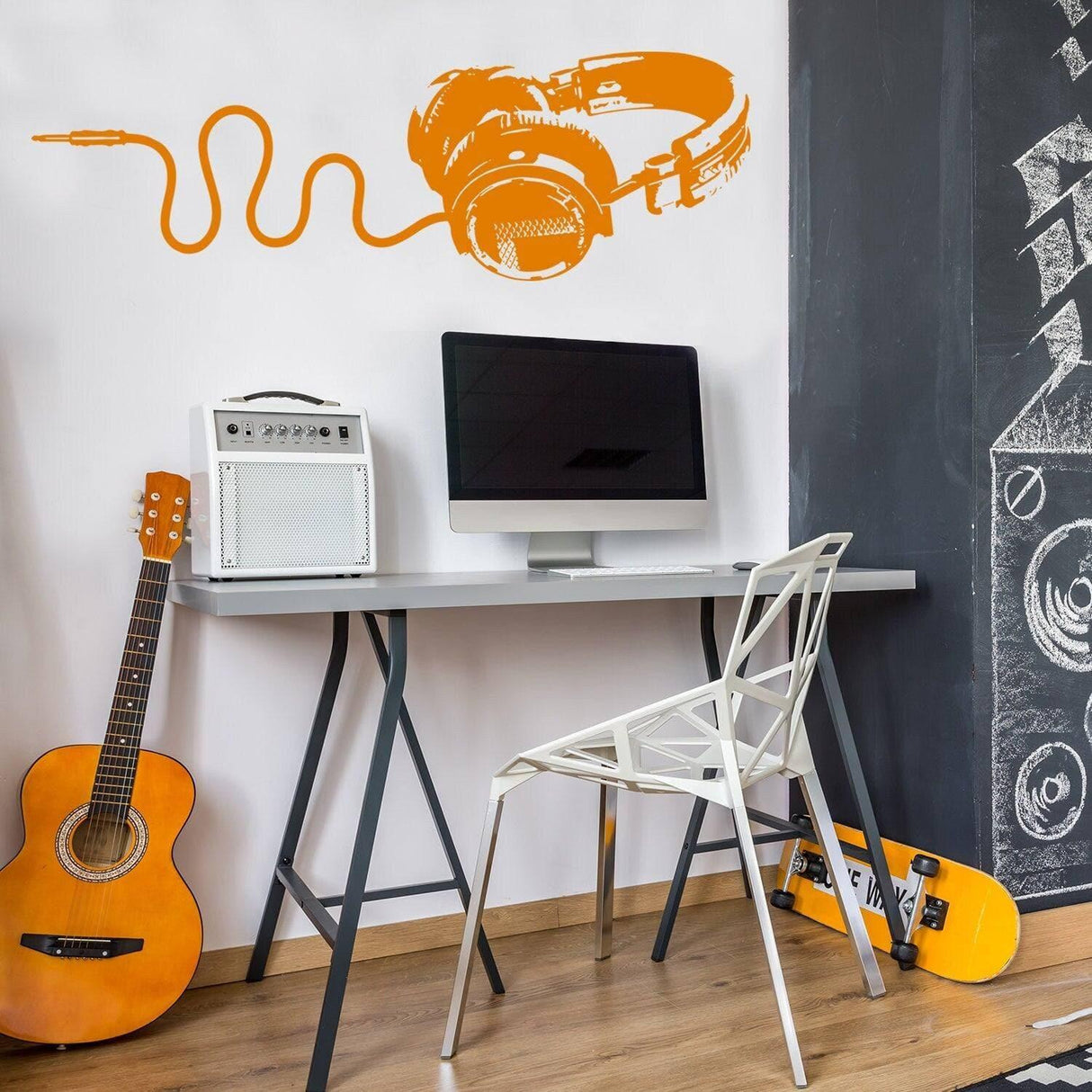 Decorative vinyl wall decal of headphones in orange, perfect for music lovers' stylish home office or studio.