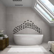 Underwater oasis wall decal set featuring black fish stickers above a modern bathtub in a stylish bathroom.