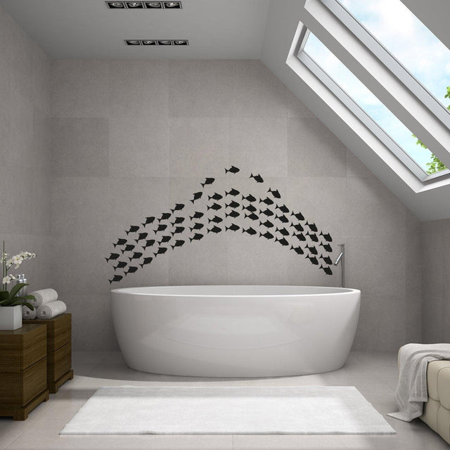 Underwater oasis wall decal set featuring black fish stickers above a modern bathtub in a stylish bathroom.
