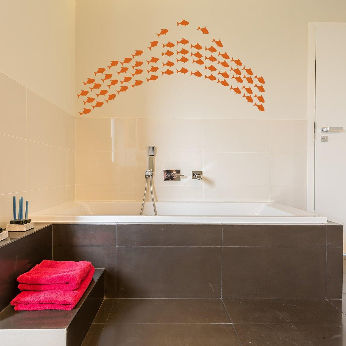 Underwater oasis wall decal featuring orange fish stickers above a modern bathtub, enhancing bathroom decor.
