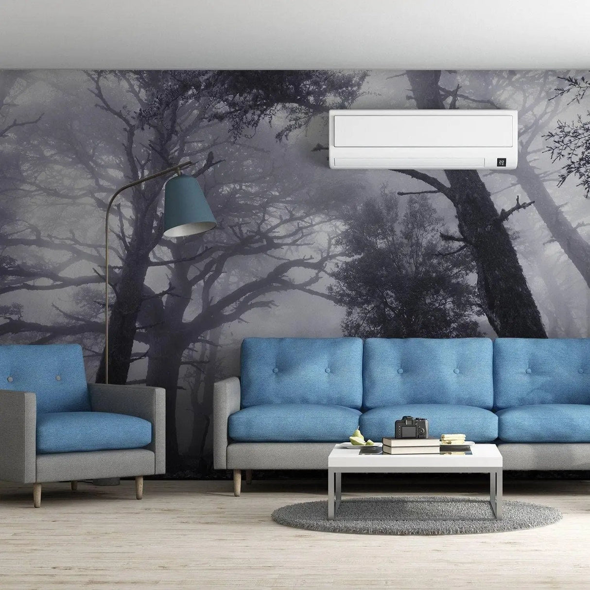 Misty forest wall mural in modern living room with blue sofas and stylish decor, creating a serene atmosphere.