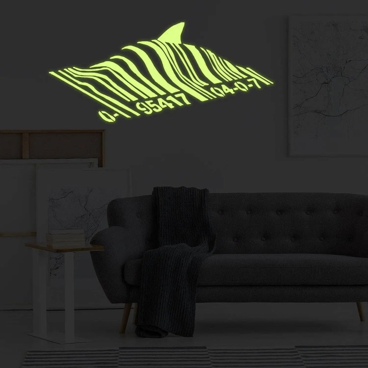 Glow in dark Banksy barcode shark wall decal illuminating a living room at night.