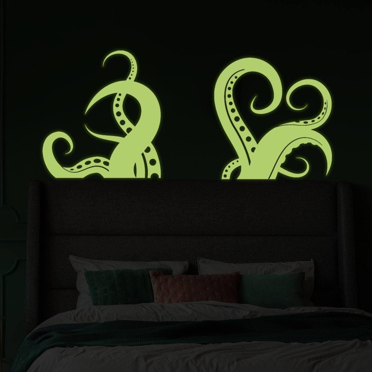 Glowing octopus tentacle wall stickers above bed, perfect for ocean-themed home decor.
