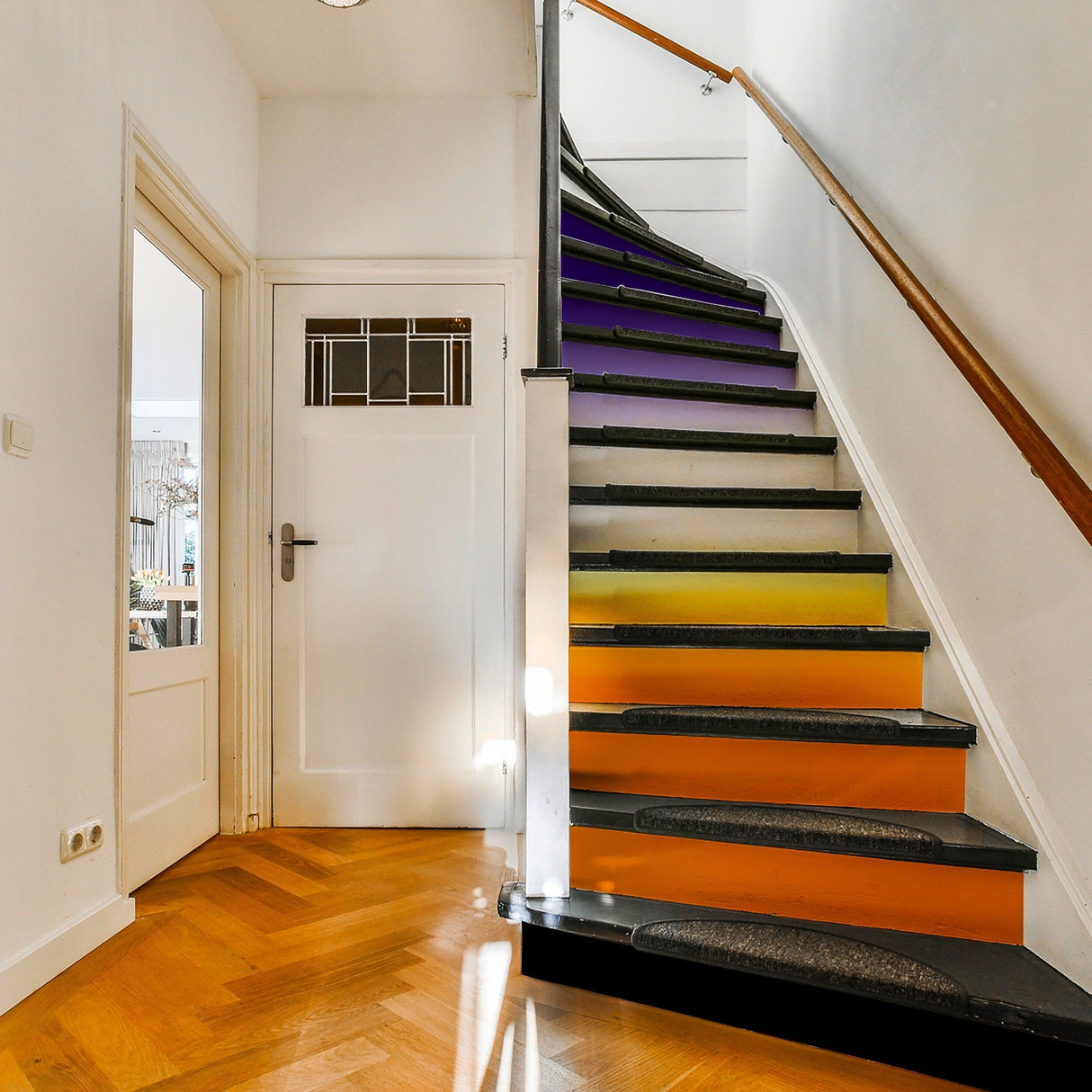 Vibrant gradient color stair risers stickers applied to a stylish staircase, transforming the space with bold colors.