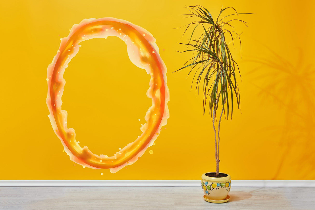 Custom orange portal wall sticker on a vibrant yellow wall, creating a dynamic space decor with a potted plant.