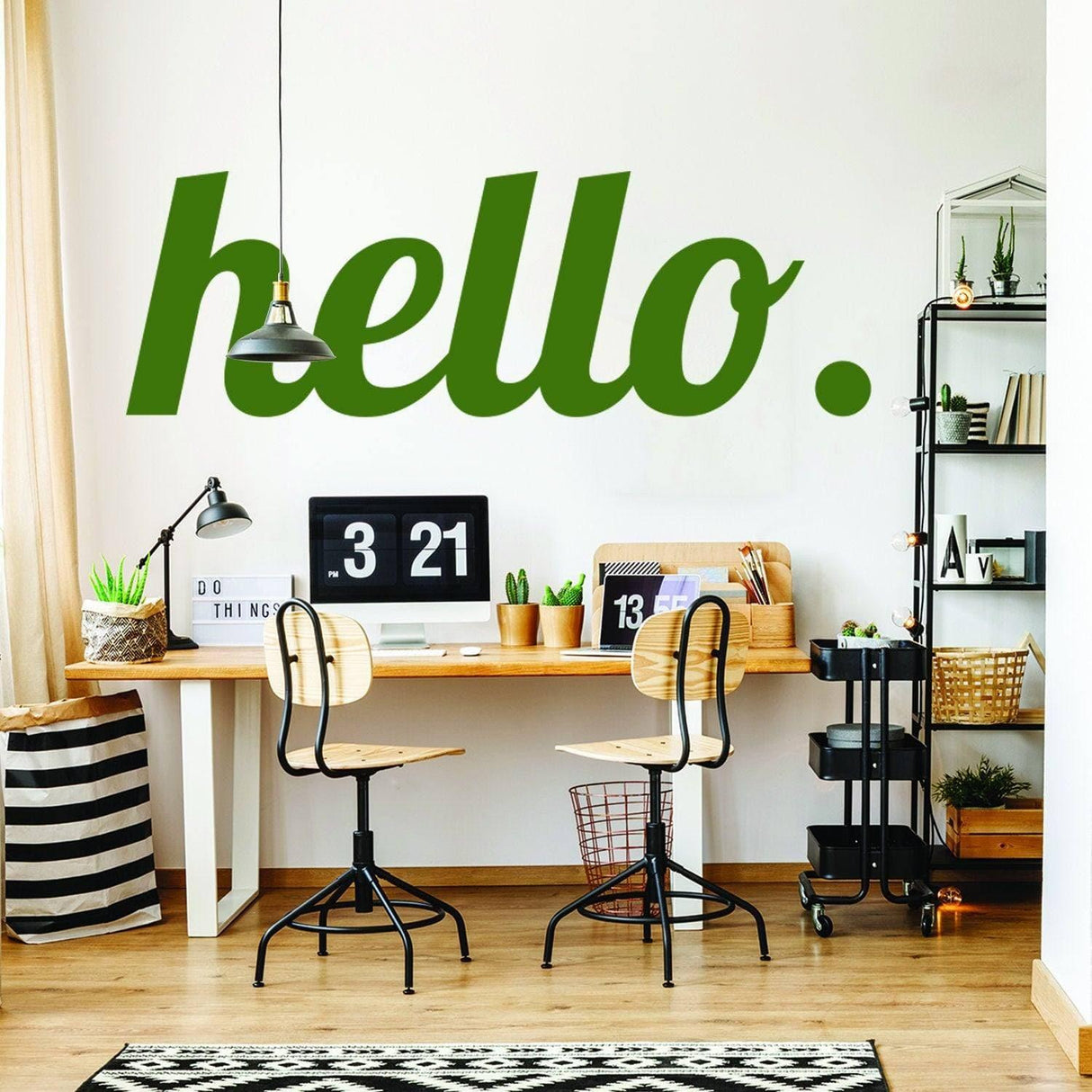 Stylish home office featuring a green 'hello.' wall decal, desk, and modern decor elements.