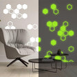 Glow in the dark hexagon wall stickers illuminating a room, showcasing decorative patterns and designs.