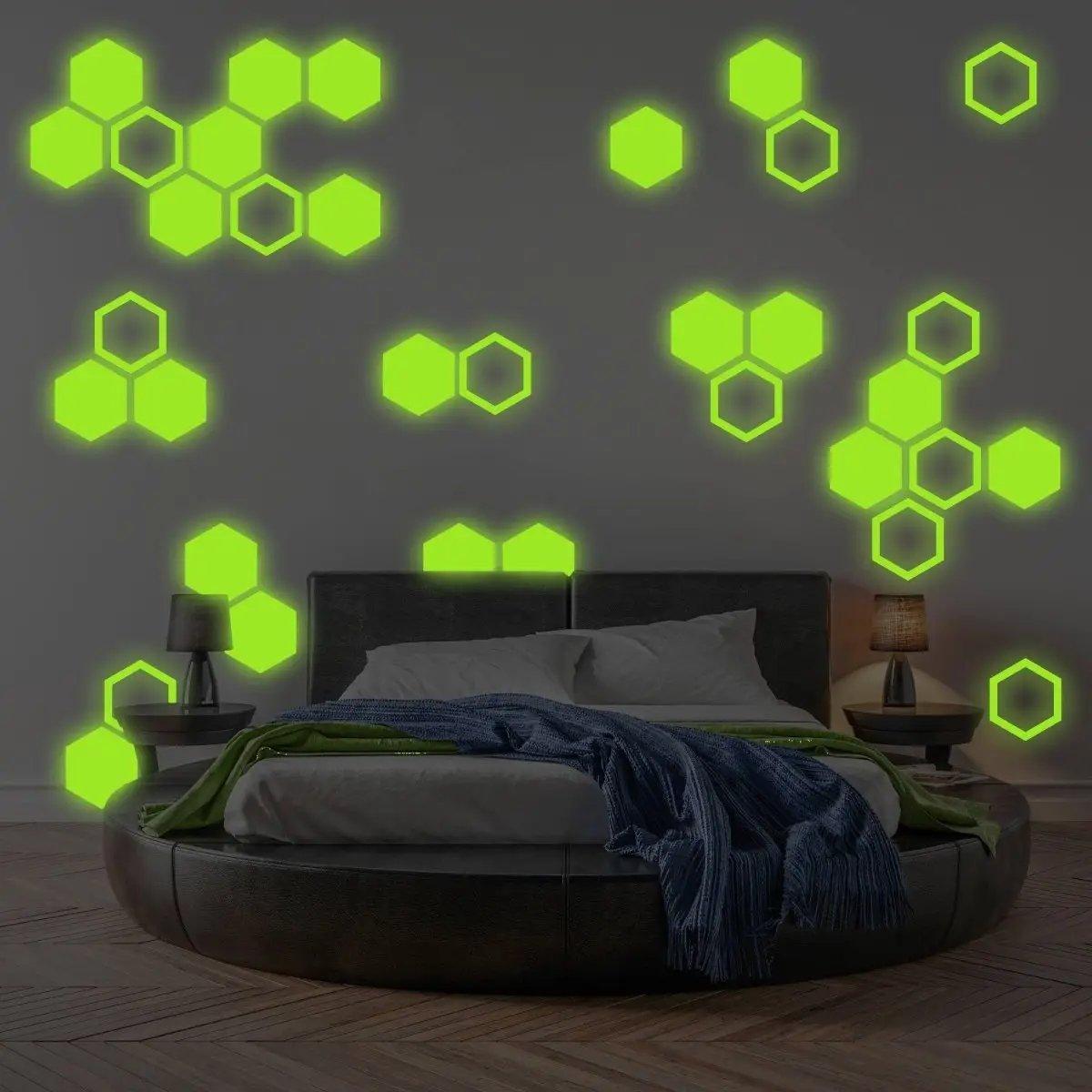 Glow in the dark hexagon wall stickers creating a playful atmosphere in a children's room with cozy bed and lamps.