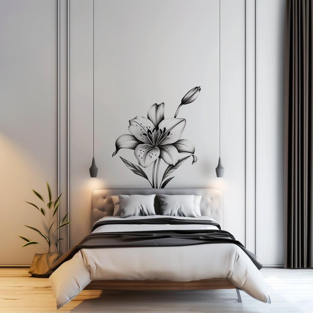 Elegant black and white lily flower wall decal above a stylish bed in a modern bedroom interior.
