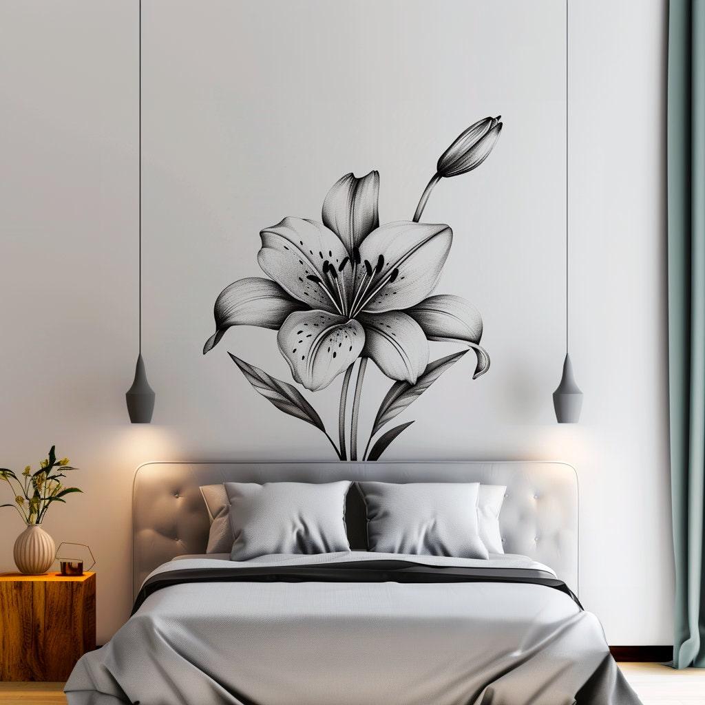 Elegant black and white lily flower wall decal above a stylish bed in a modern bedroom.