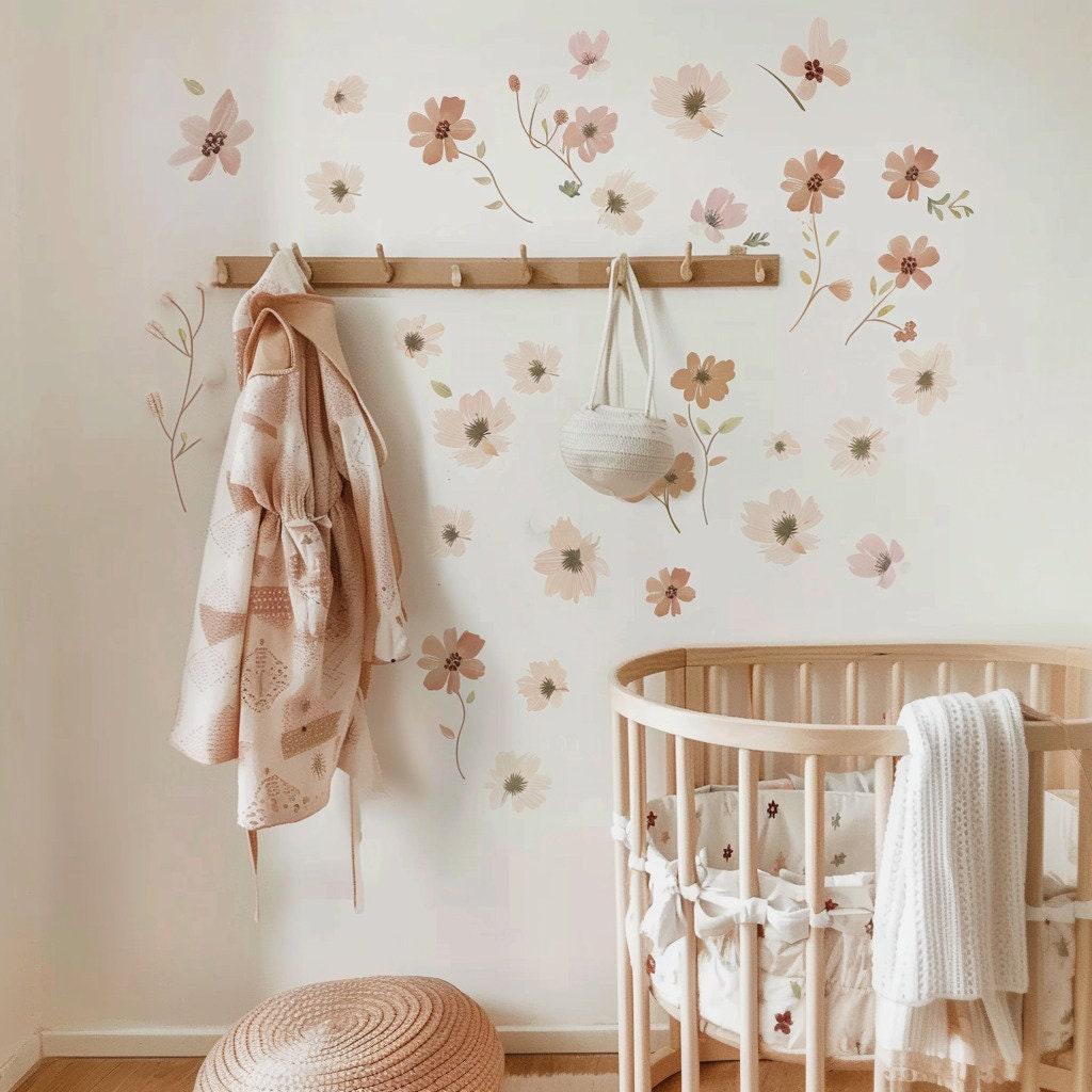 Boho nursery floral wall decals featuring soft pink flowers, enhancing a cozy baby room with removable wall stickers.