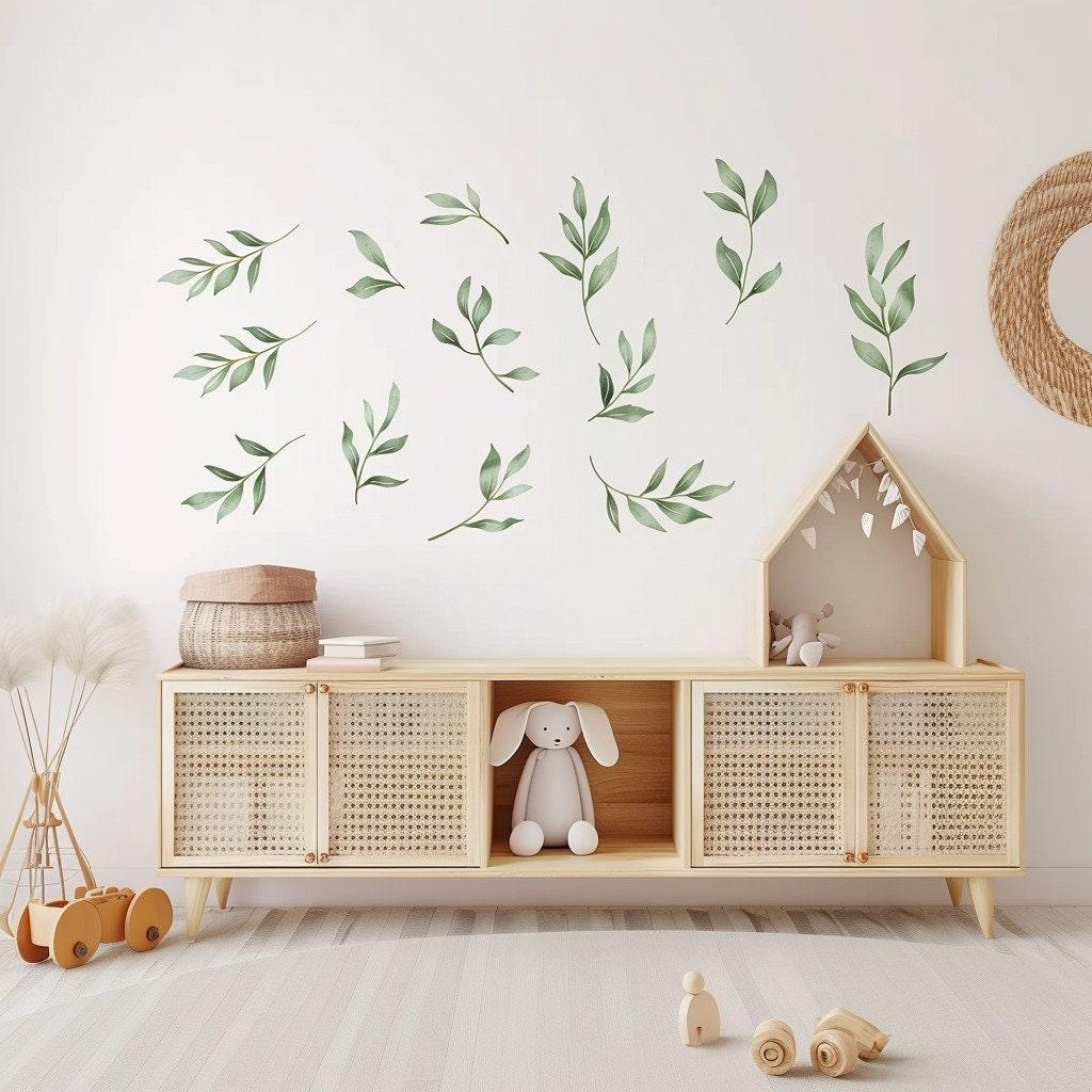 Watercolor leaf wall decals in a nursery, creating a serene and botanical atmosphere with boho decor.