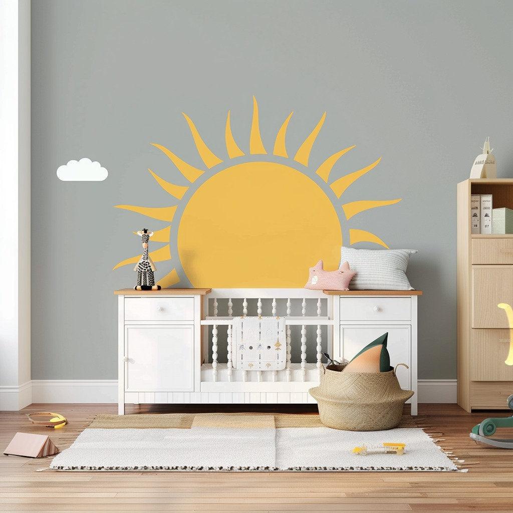 Large half sun wall decal in a cheerful nursery with a fluffy cloud and light gray walls.