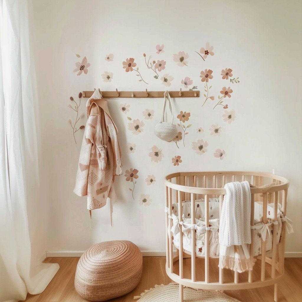 Boho nursery featuring removable floral wall decals above a crib, creating a charming and serene atmosphere.