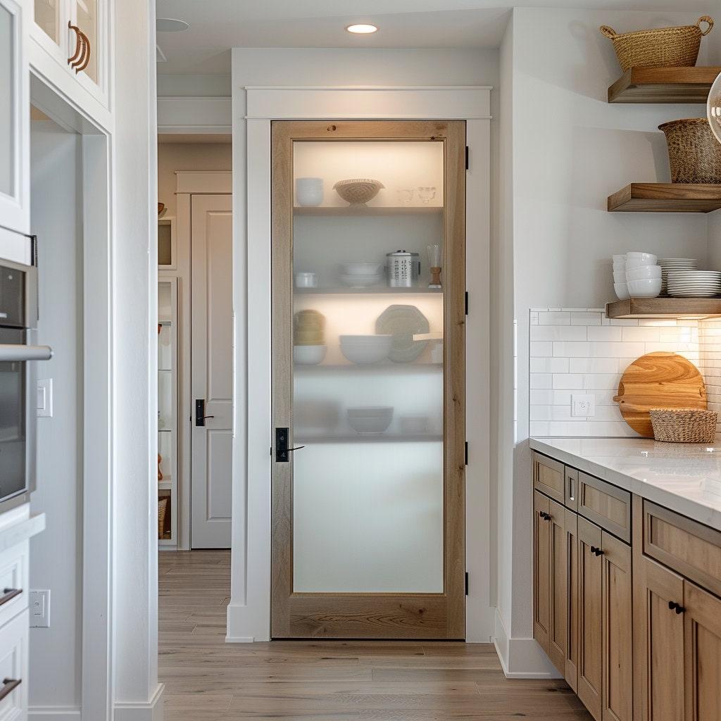 Frosted glass door with wood frame in a modern kitchen, featuring shelves and stylish decor.