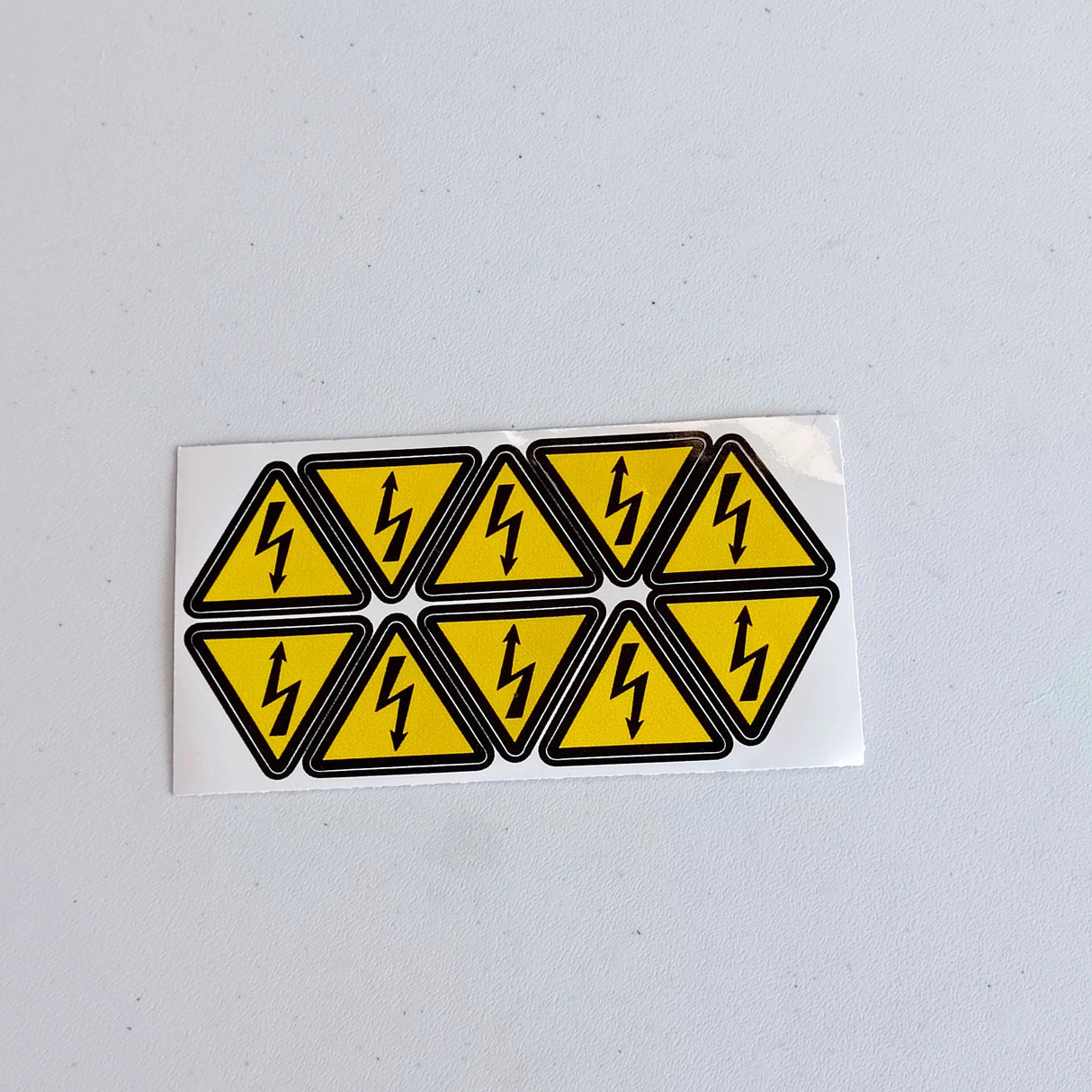 High voltage electrical shock hazard stickers, pack of 10 yellow triangle warning decals for safety.