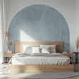 Modern bedroom featuring a sky blue half-circle wall decal above a wooden bed with neutral bedding.
