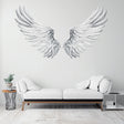 Elegant large angel wings wall decal in minimalist living room decor with white sofa.