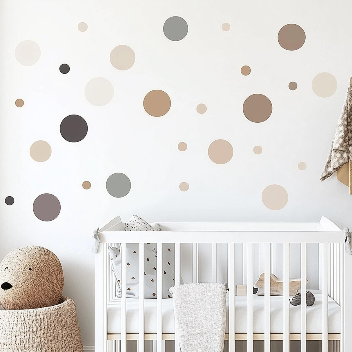 Neutral circle wall decals in various sizes on a nursery wall, enhancing a soft and modern baby room decor.