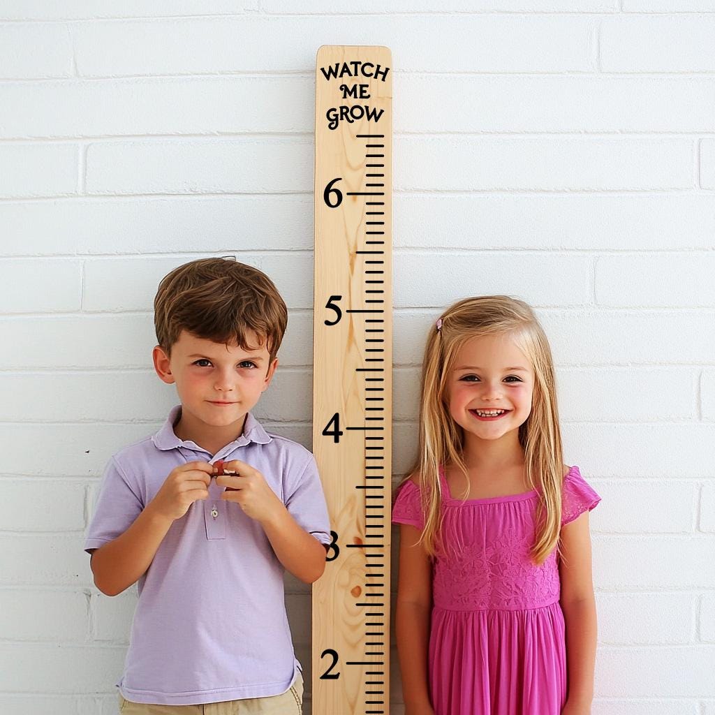 Children standing beside a wooden height ruler growth chart decal, measuring their height together.