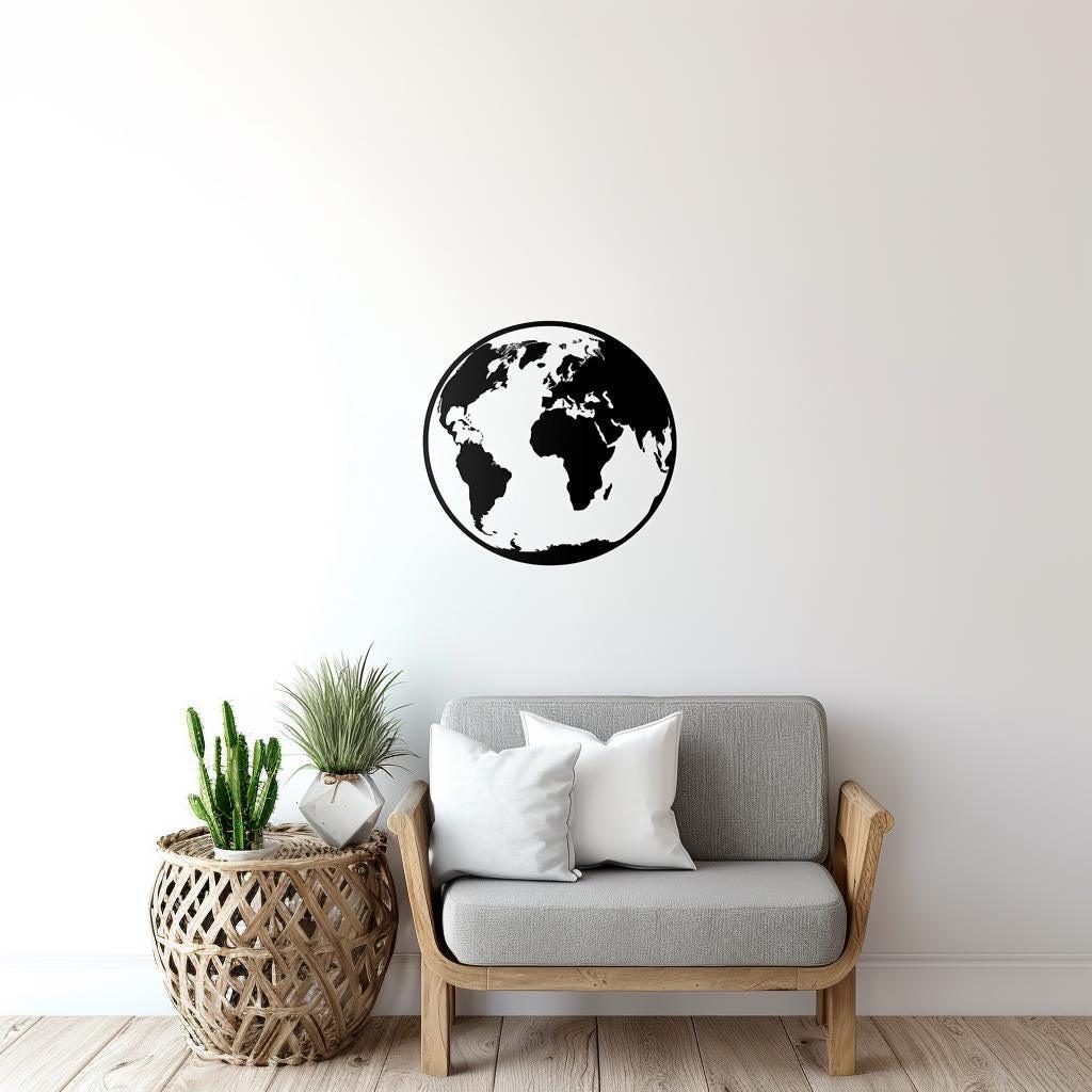 Minimalist black globe wall decal above modern gray couch in stylish living room decor.