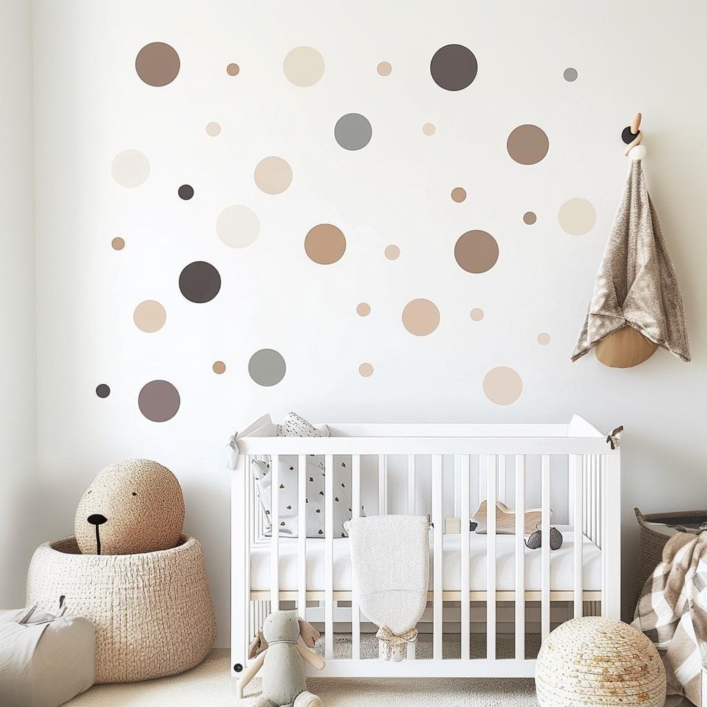 Neutral beige and grey circle wall decals in a modern nursery with a crib and stuffed toys.