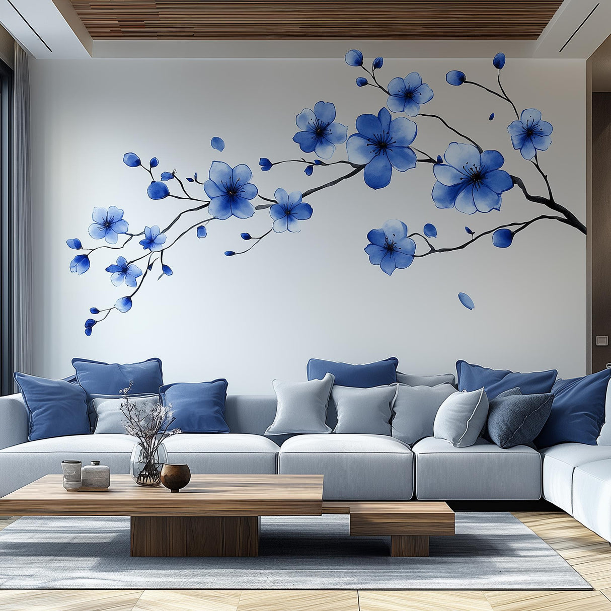 Blue flower branch wall decal in modern living room, featuring elegant blue blossoms and cozy couch decor.