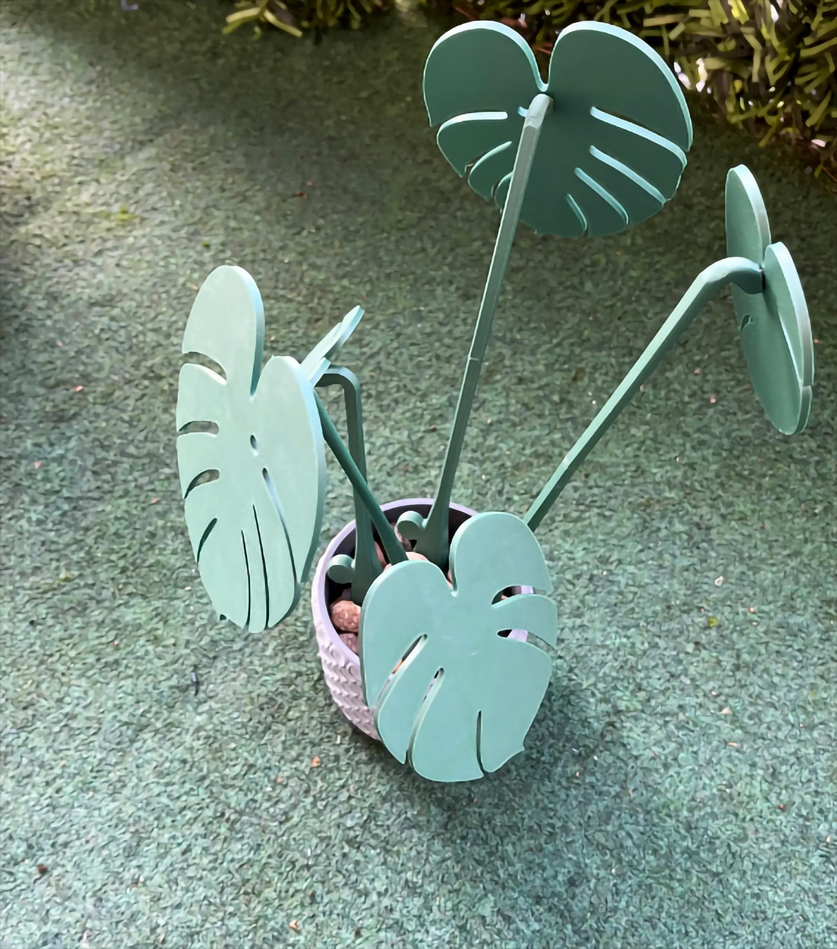 Monstera leaf coasters in a decorative planter, adding style and greenery to your home decor.